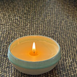 Hand-poured fragranced beeswax candle in handmade pottery.